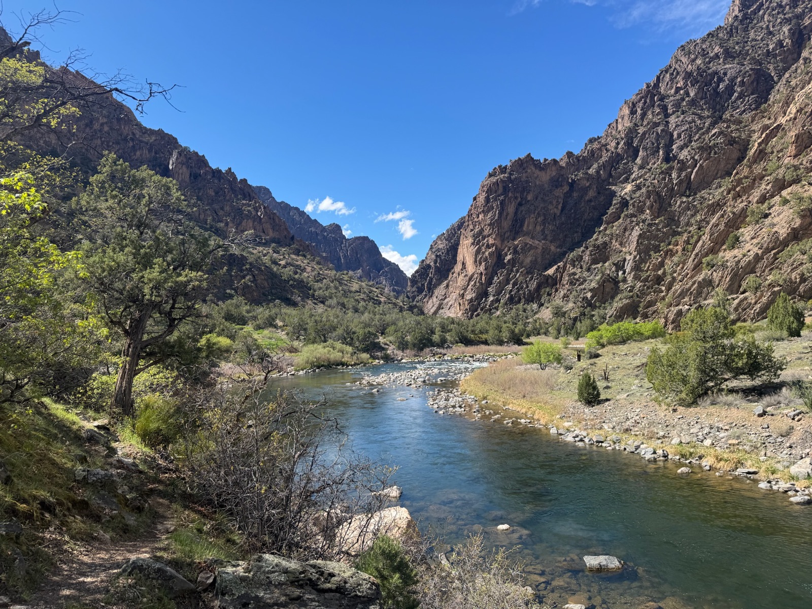 River winding through a rocky canyon under a blue sky
